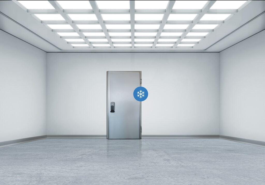 Sterile white room with a stainless freezer door marked by a blue snowflake.