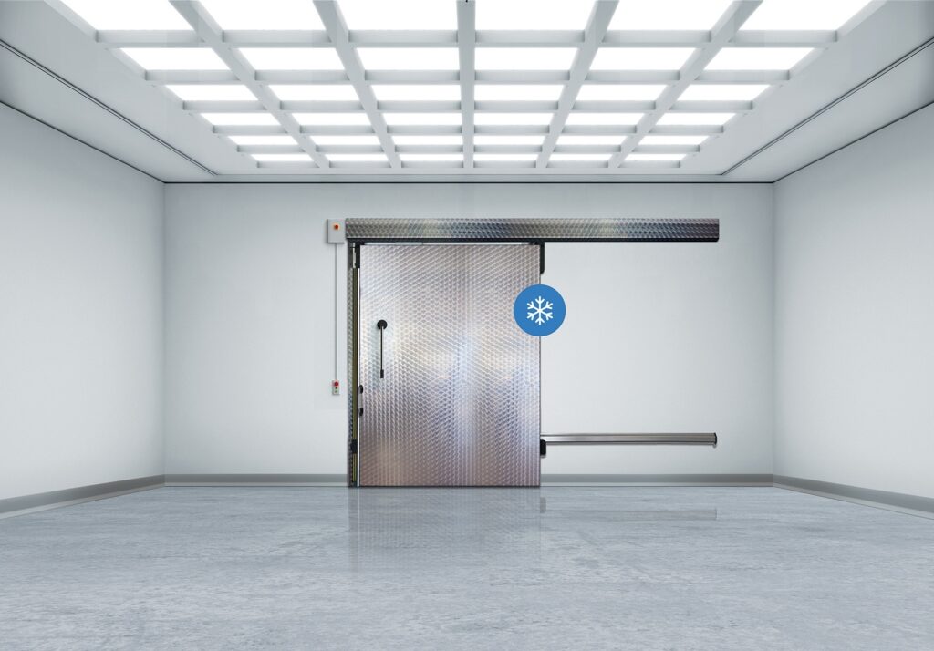 Industrial room with a metallic sliding freezer door
